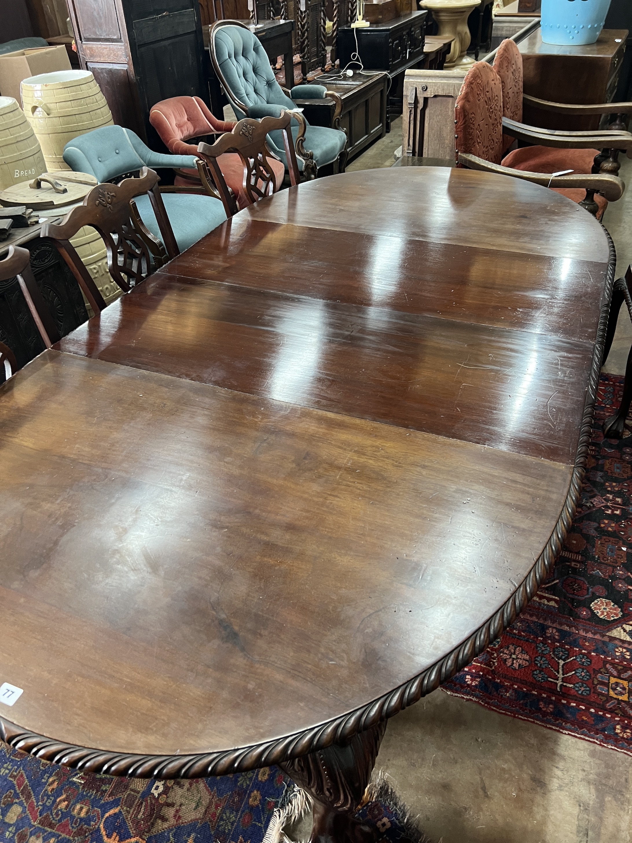 A 1920's Chippendale revival mahogany oval topped extending dining table, 238cm extended, two spare leaves, depth 120cm, height 76cm